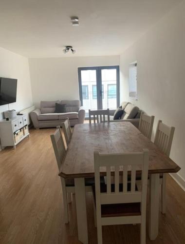 a living room with a wooden table and chairs at Best Location in Belfast! Free parking in Belfast