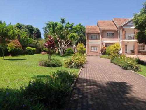 a large house with a brick driveway at Lakeview Serenity in Entebbe