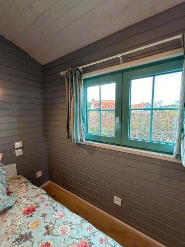 a bedroom with a bed and a window at La Bohème in Merendree