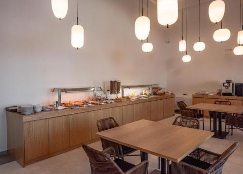 a restaurant with tables and chairs and lights at Sampatiki Suites & Spa - Luxury Seaview Suites - Opened 2024 in Leonidion