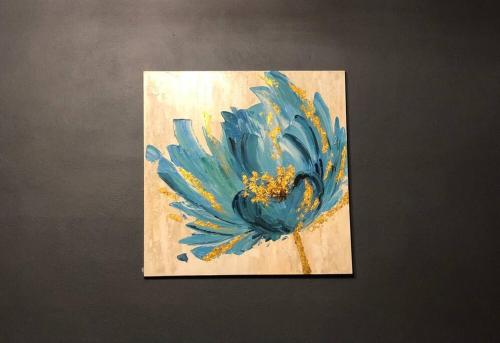 a painting of a blue flower on a wall at Stay with Class in the heart of wine country in San Antonio de las Minas