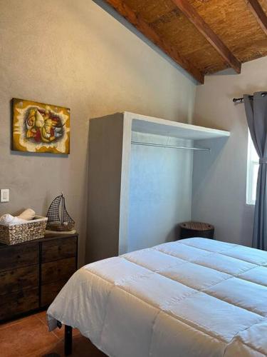 a bedroom with a white bed and a window at Stay with Class in the heart of wine country in San Antonio de las Minas