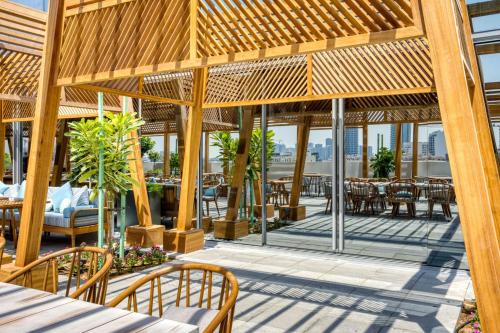 a patio with tables and chairs on a building at The First Collection Dubai Jumeirah Village Circle, a Tribute Portfolio Hotel in Dubai