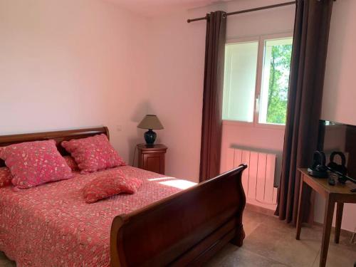 - une chambre avec un lit doté de draps rouges et une fenêtre dans l'établissement Agréable maison dans les vignes, 8 min de la plage, à Aléria