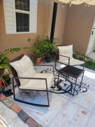 two chairs and a table on a patio at The Surada Bay 2 bedrooms in Old Harbour