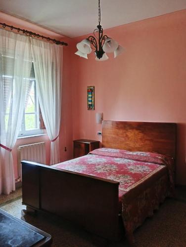a bedroom with a large bed and a window at BeB Angelini dal 1911 in Lucca