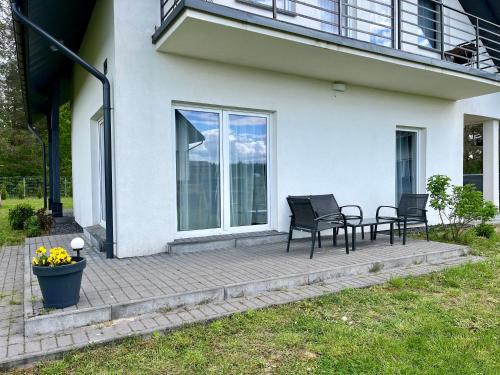 a patio with two chairs and a table at Gościniec Wigry in Walne