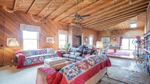 a living room with couches and a ceiling fan at Big Family Lodge near ARK Sleeps 16 in Williamstown