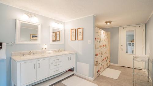 een witte badkamer met 2 wastafels en een spiegel bij Big Family Lodge near ARK Sleeps 16 in Williamstown