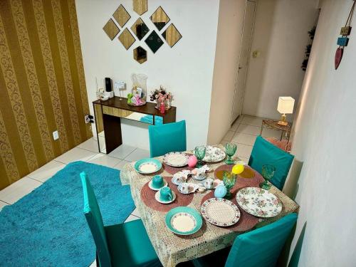 a dining room with a table with plates and chairs at Apartamentos a 2 min. da Praia, localização exclusiva in Recife