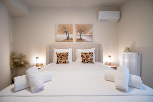 a bedroom with a large white bed with two chairs at Ilisia 2 person apartment by MPS in Athens