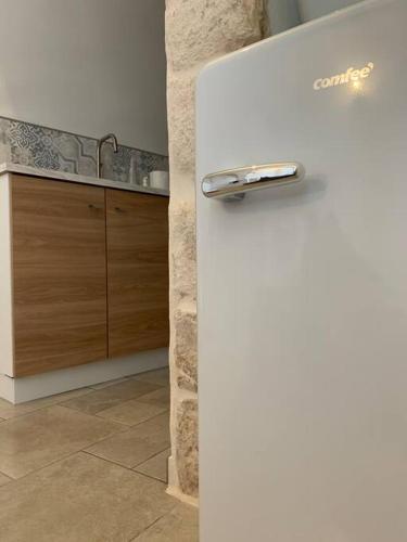 a white refrigerator in a kitchen with a counter at Franco Deluxe home in Ceglie Messapica