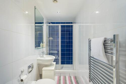 a white bathroom with a toilet and a sink at Charming 1-Bed Apartment in Leeds in Leeds