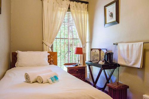 Ένα ή περισσότερα κρεβάτια σε δωμάτιο στο RIETONDALE LODGE