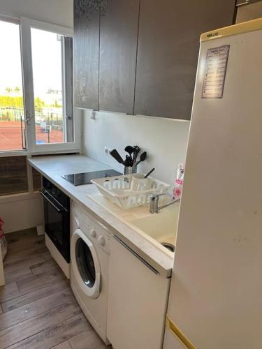 une cuisine avec un évier et une machine à laver dans l'établissement Charmant Studio équipé à Nice, à Nice