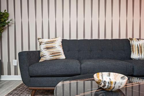 a living room with a blue couch and a table at Vibrant 3BD in SylvanHills Near Southside Beltline in Atlanta