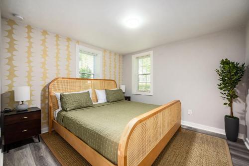 a bedroom with a bed with a wooden head board at Vibrant 3BD in SylvanHills Near Southside Beltline in Atlanta