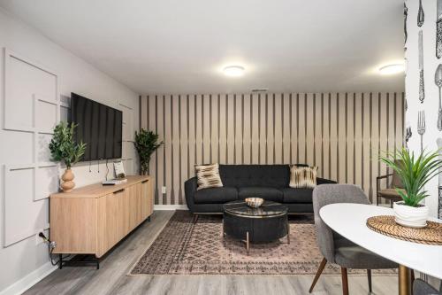a living room with a couch and a table at Vibrant 3BD in SylvanHills Near Southside Beltline in Atlanta