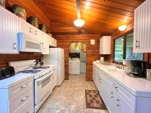 a kitchen with white appliances and a wooden ceiling at Hale Sweet Hale as seen on HGTV in Volcano