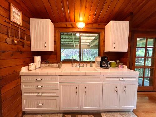 a kitchen with a large sink and a window at Hale Sweet Hale as seen on HGTV in Volcano