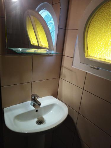 a bathroom with a sink and a window at Filio Rooms in Nikiti