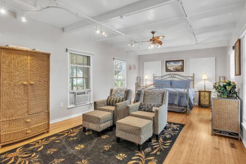 a living room with a bed and chairs in it at Lake Silver Retreat lll in Winter Haven