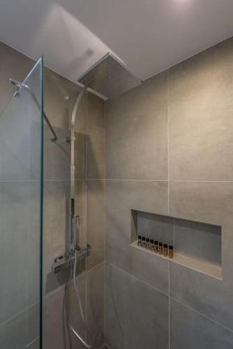 a shower with a glass door in a bathroom at Alisahni Studio Sea View in Paleochori