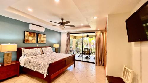 a bedroom with a bed and a ceiling fan at Monte Carlo Luxury Condominiums in Jacó