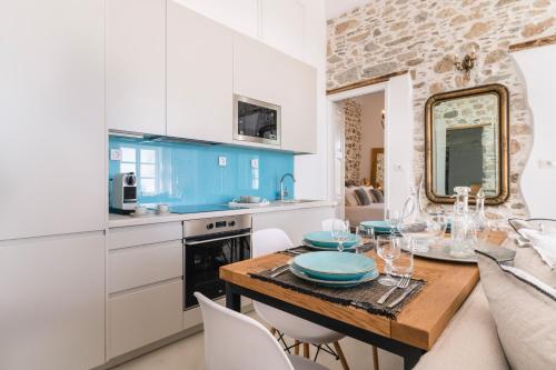 a kitchen and dining room with a table and chairs at Glaukopis Retreat in Ano Syros