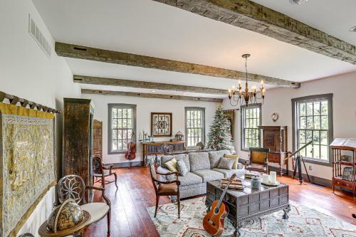 a living room with a couch and a table at Spacious and Historic Cabin in New Haven with Pond! in New Haven