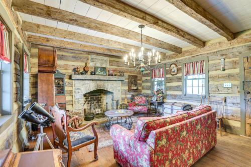 a living room with a couch and a fireplace at Spacious and Historic Cabin in New Haven with Pond! in New Haven