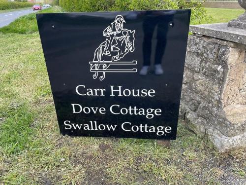 a sign for a car house dover cottage swallow cottage at LetAway - Dove Cottage Pickering in Pickering