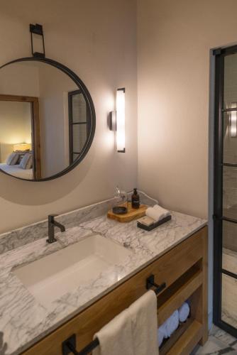 a bathroom with a sink and a mirror at La Casa Rodavento in Valle de Bravo
