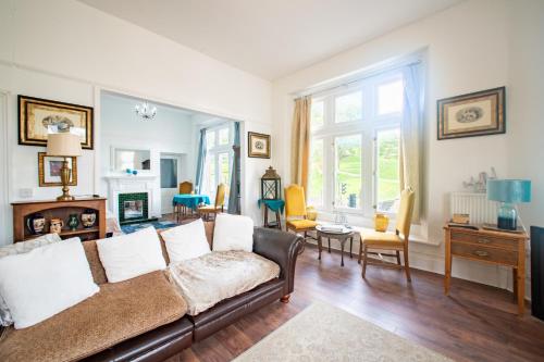 a living room with a couch and a table at Spring View Apartment in Buxton