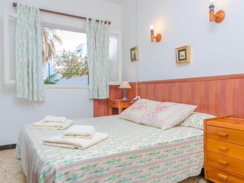 a bedroom with a bed with towels on it at Can Nicolau - Villa With Private Pool In Colònia De Sant Pere Free Wifi in Colonia de Sant Pere