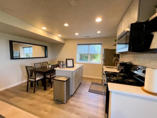 a kitchen with a table and a dining room at City View Retreat 2 BR 1 B in Draper