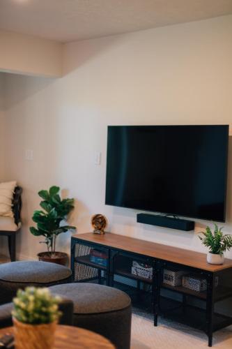 a living room with a flat screen tv on a table at City View Retreat 2 BR 1 B in Draper