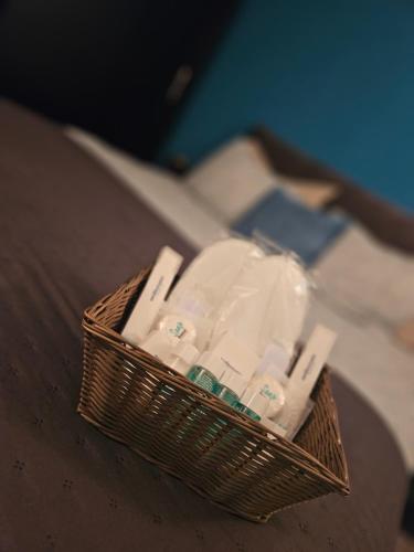 a basket filled with toothpaste and toothbrushes on a table at Apartman Dea Brseč in Brseč
