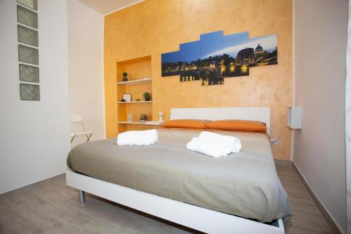 a bedroom with a large bed with two pillows at La finestra sul pincio in Civitavecchia