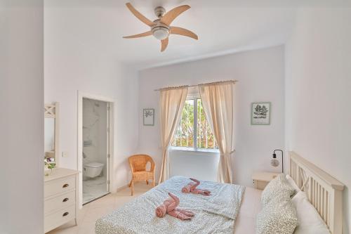 a bedroom with a bed with two stuffed animals on it at Ocean View Luxury Villa in Los Cristianos