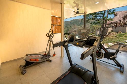 a fitness room with a gym with a view at Hotel Alto de Pajas Boutique by H&R in Villeta