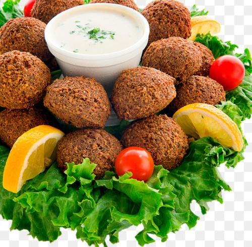 a plate of food with falafel and sauce at Golden pyramids view in Cairo