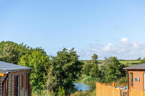 a view of a river from between two buildings at 16 Lakeview in Crantock