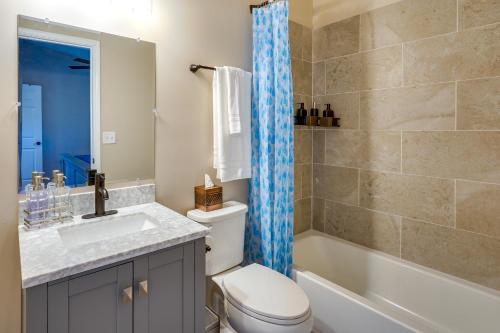 een badkamer met een toilet, een wastafel en een bad bij Serene Logan Retreat with Private Hot Tub and Fire Pit in Logan