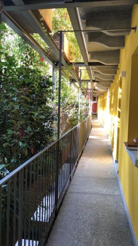 a hallway of a building with a fence and plants at Residence Casa Coppa Appartamento Aster in Omegna