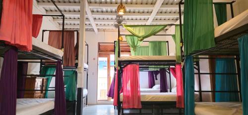 a group of four bunk beds in a room at Casa Oro Eco Hostel in San Juan del Sur