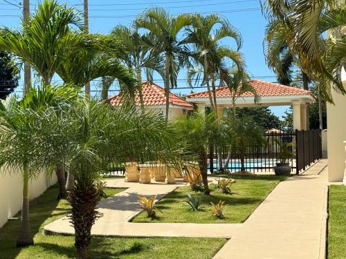 a house with palm trees in the yard at Ocean Luxe in Paradise - Le Paradis Royal in Rincon