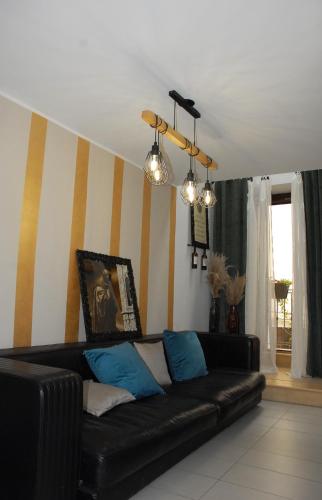 a black couch in a living room with striped walls at Publiohouse23 in Sulmona