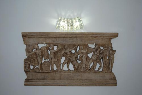 a wooden shelf with a chandelier on top of it at Publiohouse23 in Sulmona
