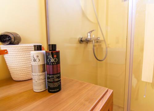 a bathroom with a shower and a bottle of shampoo at Summer Villa Barbara ,private pool in Mikonos